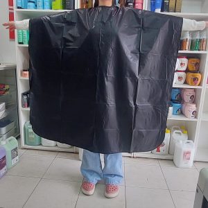 CAPA PARA TINTURA. TELA PLASTICA, LAVABLE. CUELLO CON ABROJO